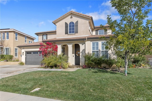 mediterranean / spanish home with stucco siding, concrete driveway, and a front yard