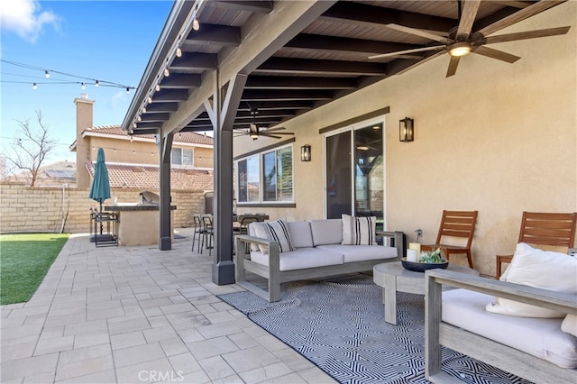 view of patio / terrace with outdoor dry bar, an outdoor hangout area, fence, and a ceiling fan