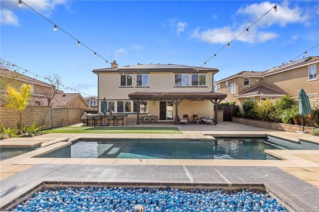 rear view of house featuring outdoor dry bar, a fenced backyard, a fenced in pool, and stucco siding