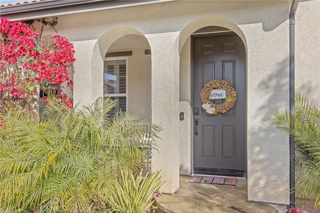 property entrance with stucco siding