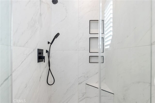 details featuring a marble finish shower