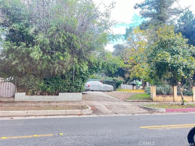 view of road with sidewalks and curbs