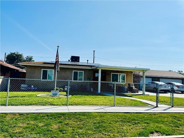 single story home with solar panels, a front yard, fence private yard, and stucco siding