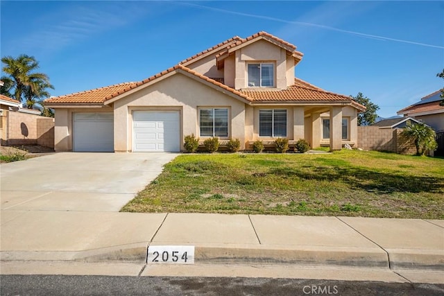 mediterranean / spanish-style house with a garage, concrete driveway, a front lawn, and stucco siding