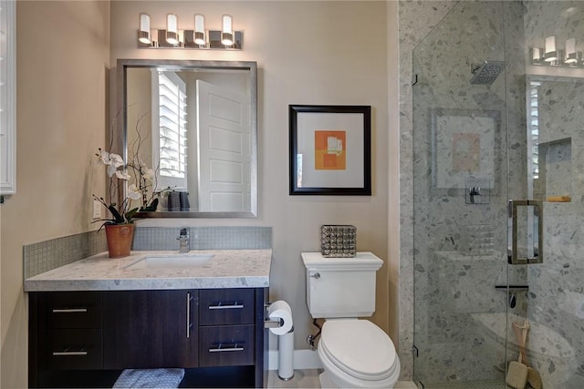 full bath featuring toilet, a shower stall, and vanity