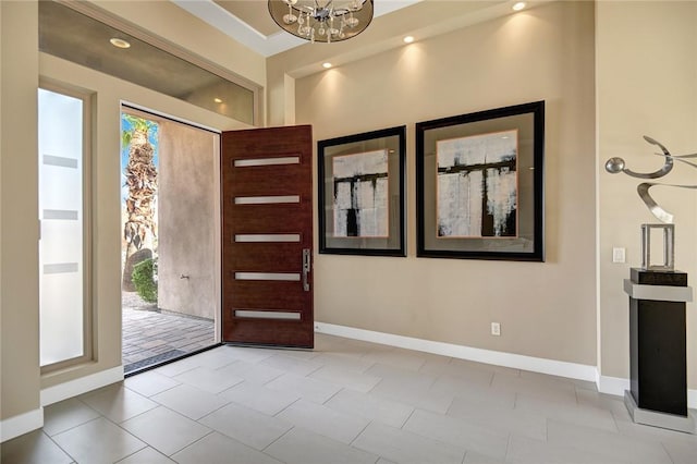 foyer entrance featuring recessed lighting, baseboards, and an inviting chandelier