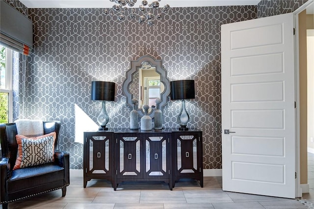 sitting room featuring baseboards and wallpapered walls