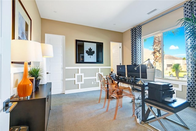 carpeted office space featuring visible vents
