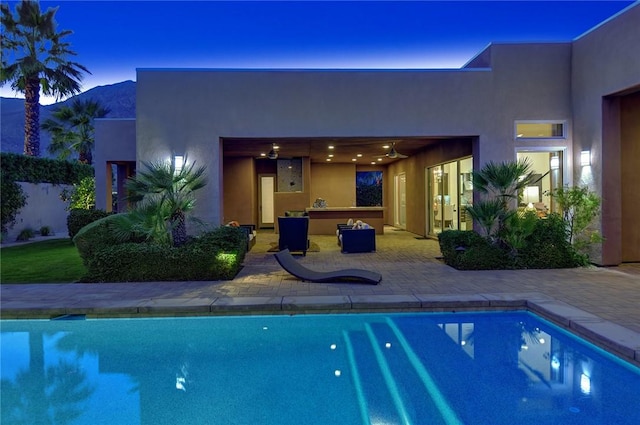 pool with a patio and a mountain view