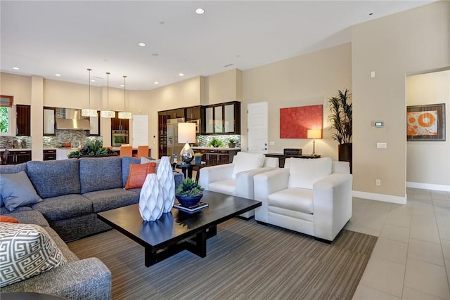 living room with recessed lighting, light tile patterned flooring, and baseboards