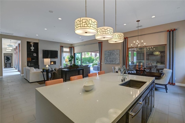 kitchen with decorative light fixtures, recessed lighting, visible vents, a sink, and dishwashing machine