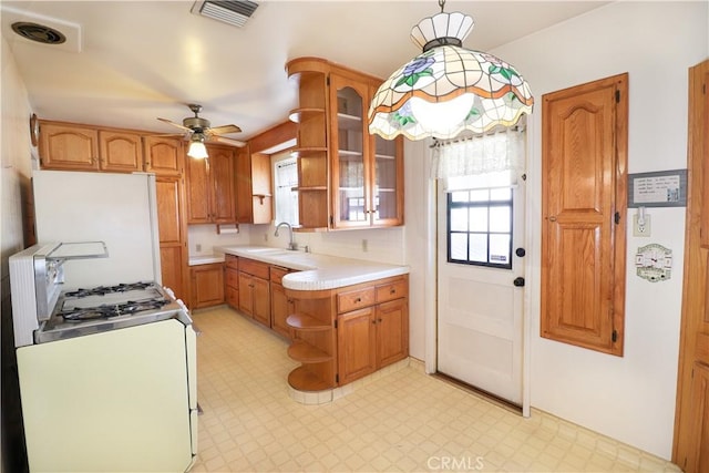 kitchen featuring white appliances, glass insert cabinets, pendant lighting, light countertops, and open shelves