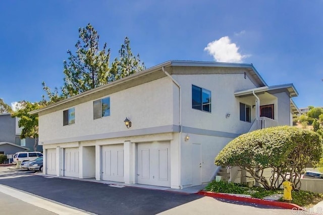 view of front facade with a garage and stucco siding