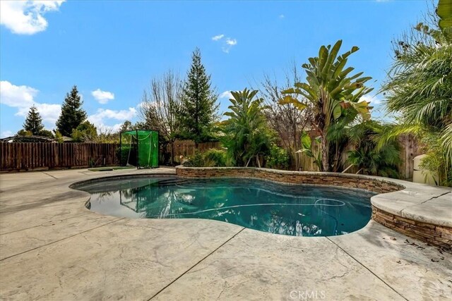 view of pool featuring a fenced in pool, a fenced backyard, and a patio
