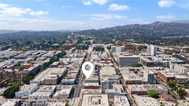 birds eye view of property with a view of city and a mountain view