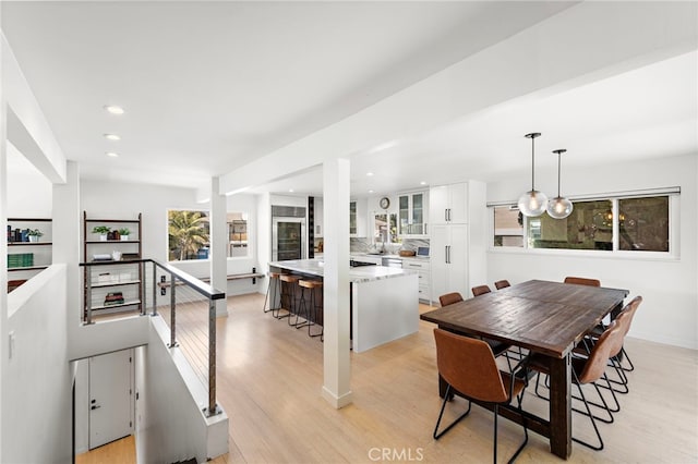 dining area featuring light wood-type flooring, baseboards, and recessed lighting