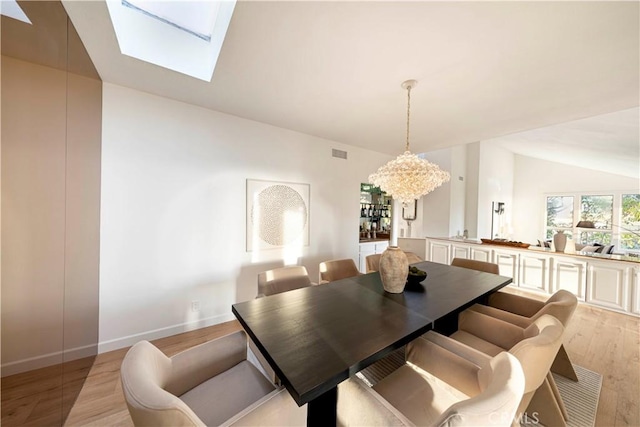 11 Montpellier, Newport Beach, CA 92660 - dining room with light wood finished floors, a skylight, vaulted ceiling, and baseboards