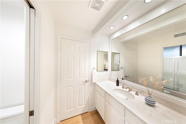 11 Montpellier, Newport Beach, CA 92660 - bathroom featuring recessed lighting, vanity, wood finished floors, and a shower with door