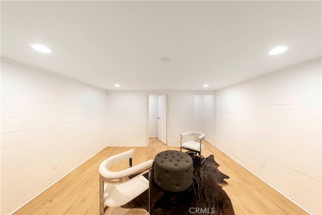 living area with light wood-style flooring and recessed lighting