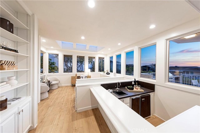 kitchen featuring light wood-style flooring, recessed lighting, white cabinets, open floor plan, and open shelves