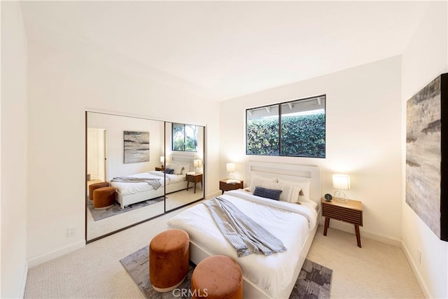 bedroom featuring light carpet and baseboards