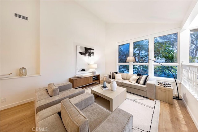 11 Montpellier, Newport Beach, CA 92660 - living area with light wood-style floors, baseboards, and high vaulted ceiling
