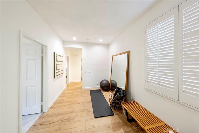 exercise room with light wood-style floors, recessed lighting, and baseboards