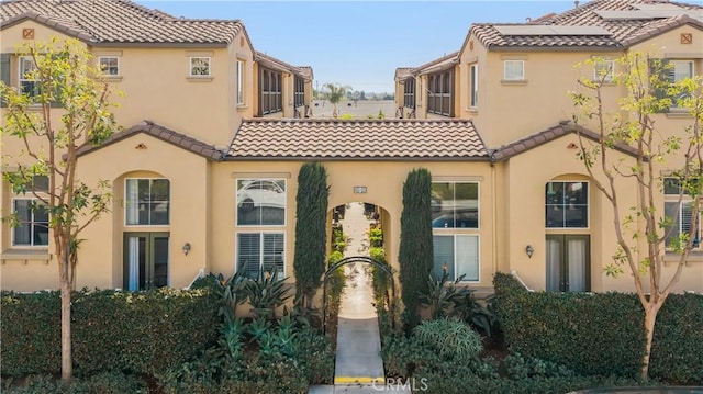 mediterranean / spanish-style home with a tile roof and stucco siding