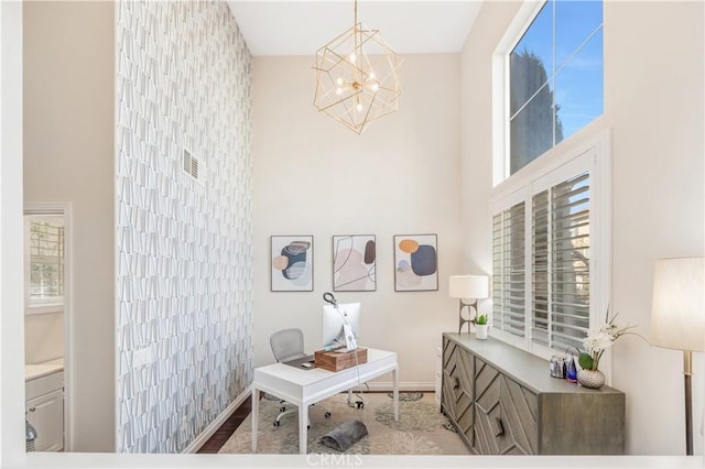 office featuring baseboards and an inviting chandelier