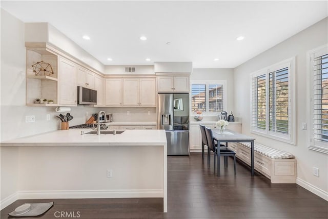 kitchen featuring dark wood-style floors, stainless steel appliances, light countertops, open shelves, and recessed lighting