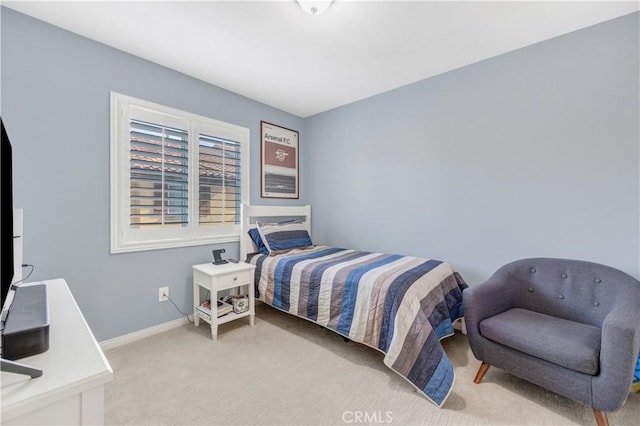 bedroom featuring baseboards and light colored carpet