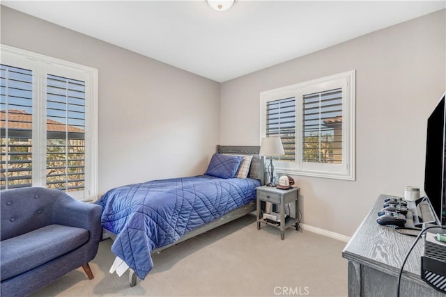 bedroom with carpet floors, multiple windows, and baseboards