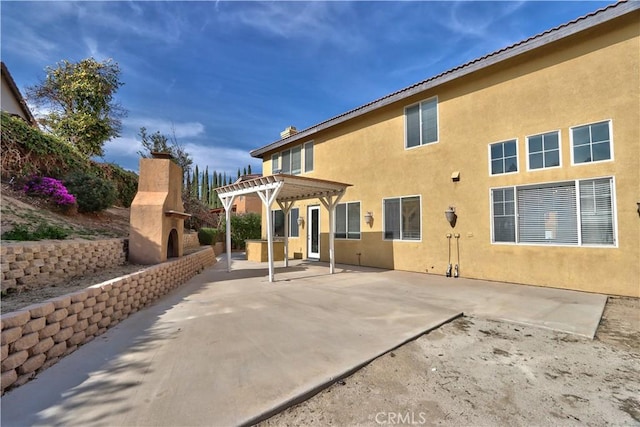 23531 Hobart Ct, Murrieta, CA 92562 - back of property featuring a patio area, a pergola, stucco siding, and exterior fireplace
