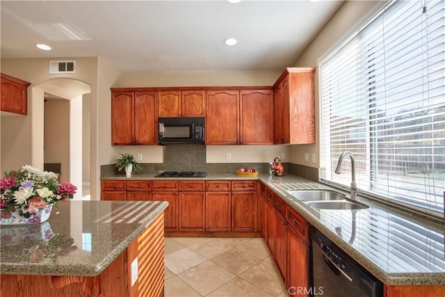 23531 Hobart Ct, Murrieta, CA 92562 - kitchen with black appliances, a sink, light stone counters, light tile patterned flooring, and arched walkways