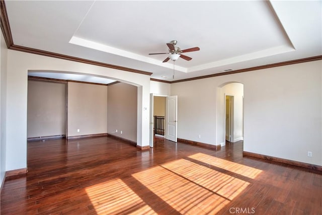 23531 Hobart Ct, Murrieta, CA 92562 - unfurnished room featuring arched walkways, a tray ceiling, ceiling fan, wood-type flooring, and baseboards