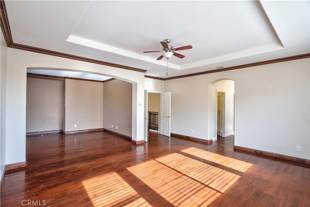 23531 Hobart Ct, Murrieta, CA 92562 - spare room with arched walkways, a raised ceiling, a ceiling fan, dark wood-style floors, and crown molding