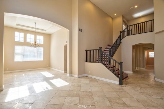 23531 Hobart Ct, Murrieta, CA 92562 - foyer entrance with arched walkways, a chandelier, a towering ceiling, stairs, and recessed lighting