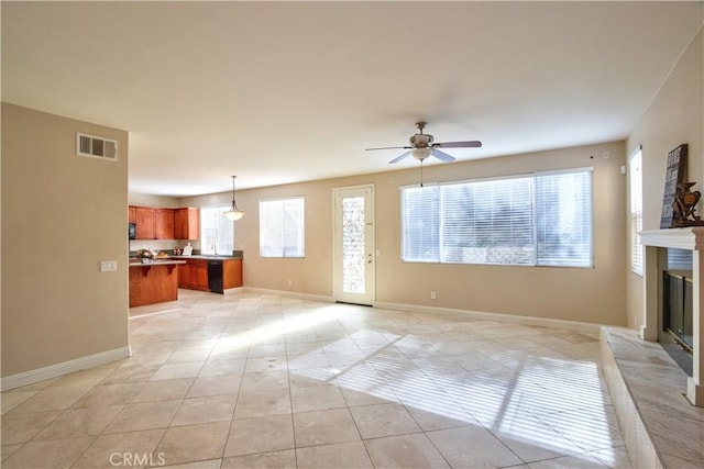 23531 Hobart Ct, Murrieta, CA 92562 - unfurnished living room with ceiling fan, light tile patterned floors, a glass covered fireplace, and baseboards