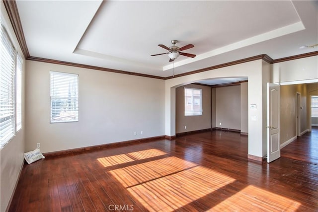 23531 Hobart Ct, Murrieta, CA 92562 - unfurnished room featuring a tray ceiling, arched walkways, ceiling fan, healthy amount of natural light, and ornamental molding
