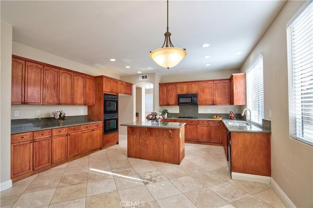 23531 Hobart Ct, Murrieta, CA 92562 - kitchen with black appliances, a sink, brown cabinetry, recessed lighting, and healthy amount of natural light