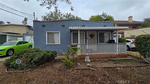 view of front of property featuring covered porch and stucco siding