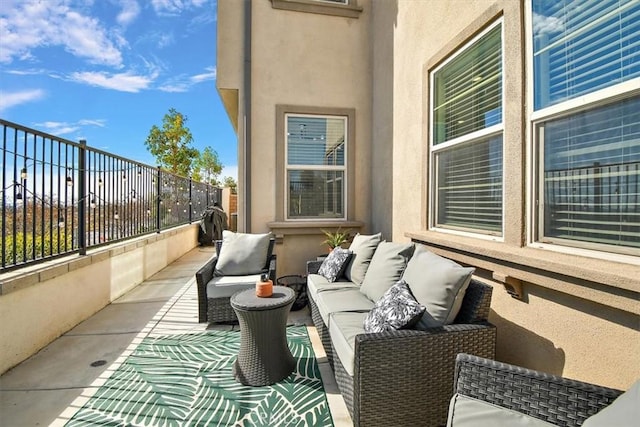 balcony with a sunroom and an outdoor living space