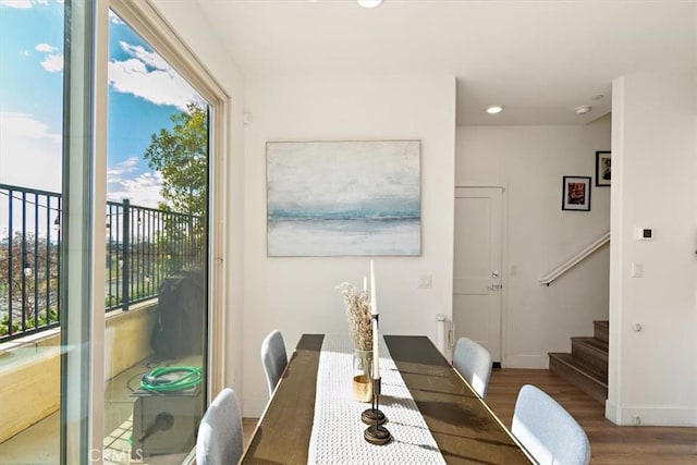 dining area featuring baseboards, stairway, wood finished floors, and recessed lighting