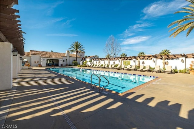 community pool featuring a patio area and a residential view