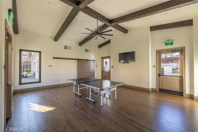 recreation room with dark wood-style floors, a barn door, and a wealth of natural light