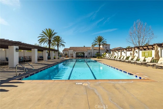 pool featuring a patio area and a residential view