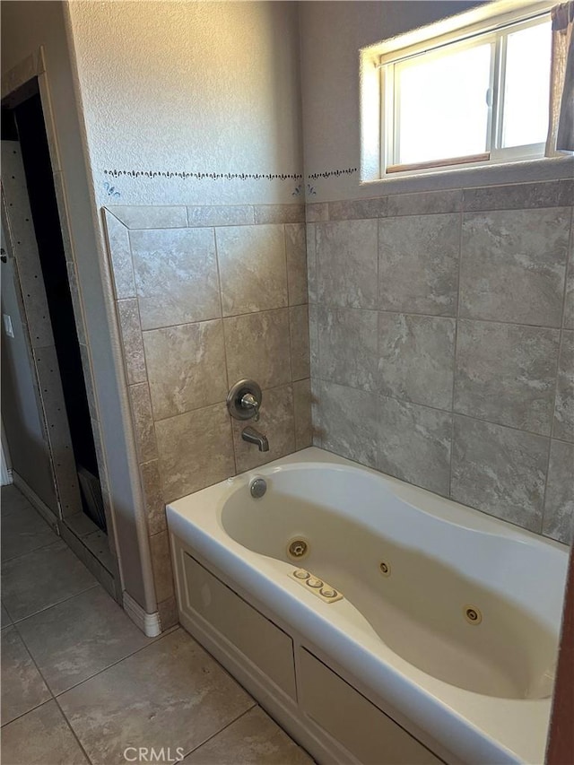 bathroom with a jetted tub and tile patterned floors