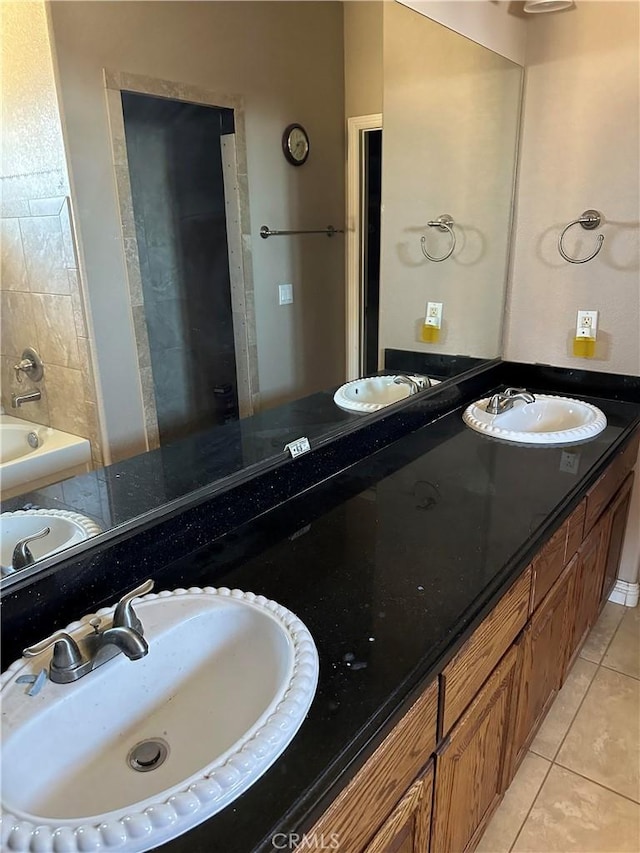 bathroom featuring double vanity, tile patterned flooring, and a sink