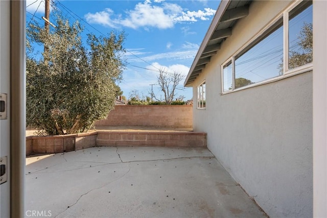 view of patio / terrace featuring fence