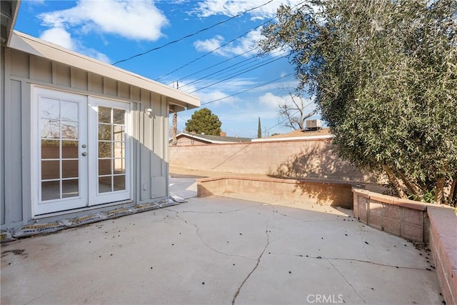 view of patio featuring french doors and fence